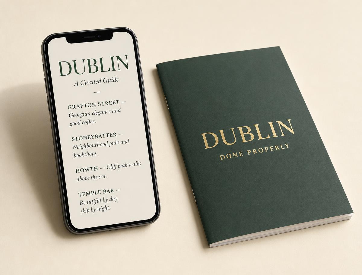 A Dublin guide open on a phone beside a deep green printed booklet